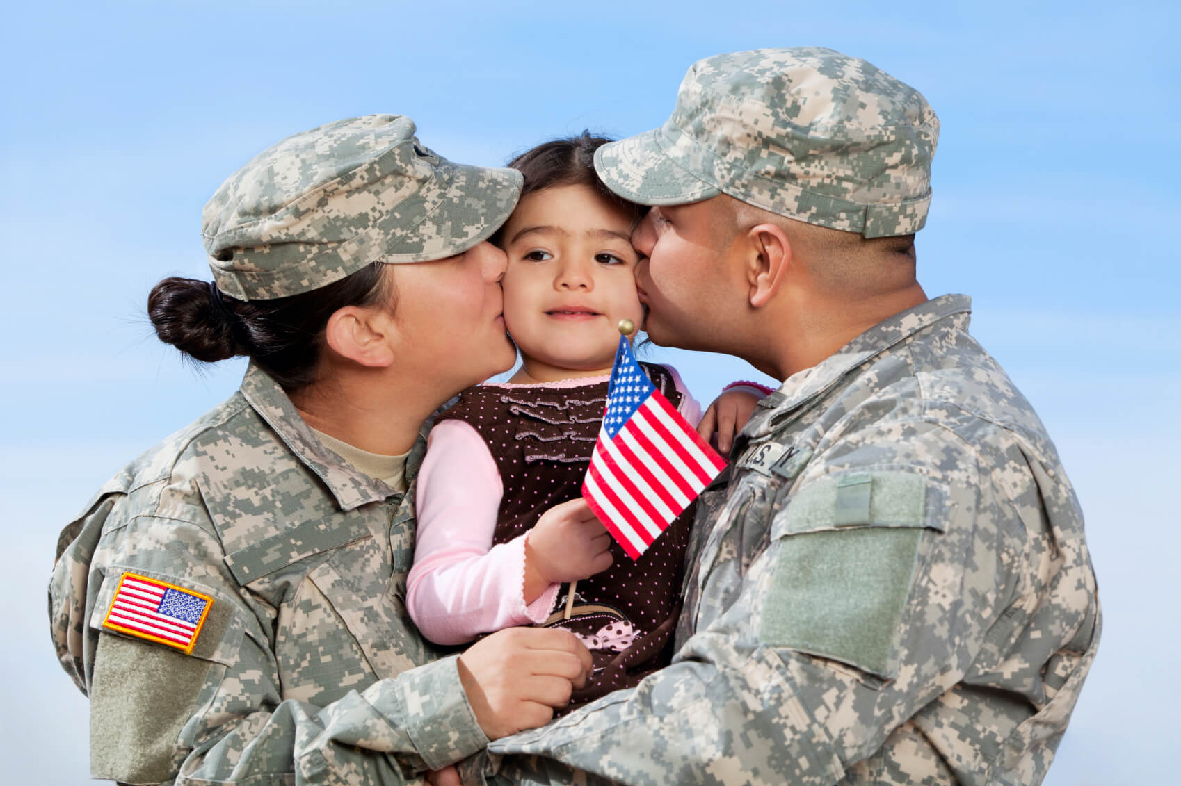 Military Mom & Dad Kissing their daughter